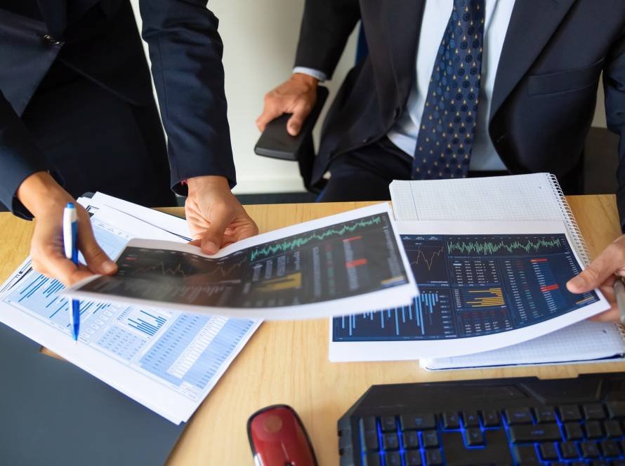 investor trader discussing statistic data holding papers with financial charts pen cropped shot broker job trading concept