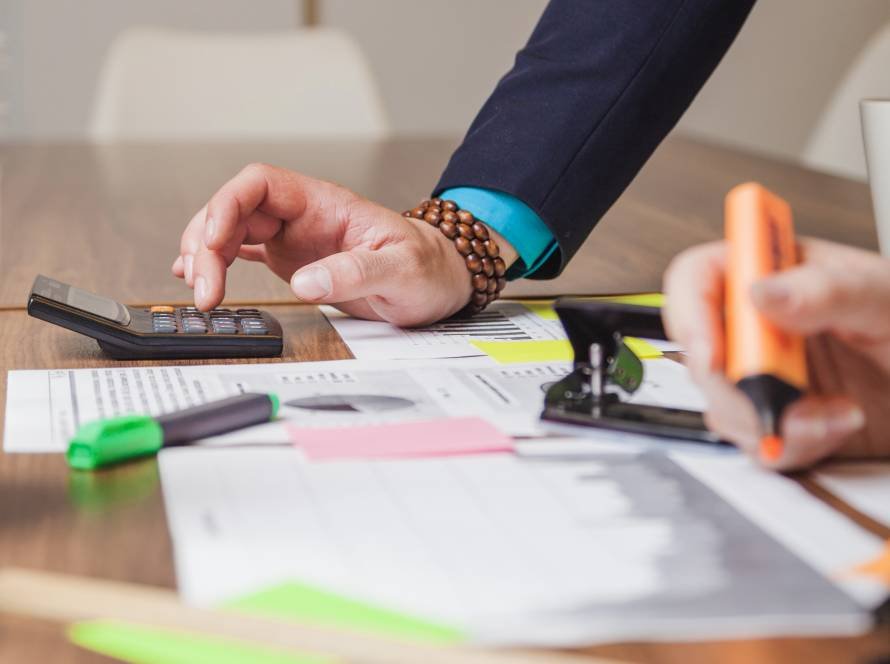 people standing leaning desk working